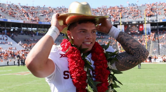Sooners quarterback Dillon Gabriel wears a lei and cowboy hat after Oklahoma’s upset of Texas
